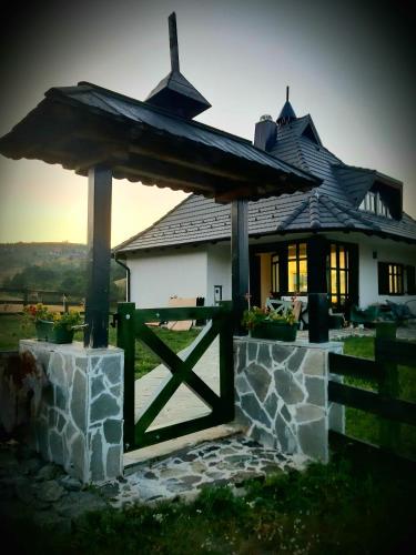 a house with a gate in front of it at Casa Mila Zlatibor in Zlatibor