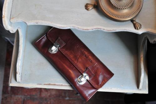 a brown leather wallet sitting on top of a table at Les Glycines Vézelay in Vézelay