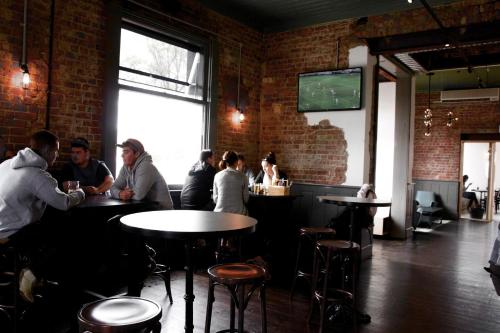 a group of people sitting at tables in a restaurant at Western Hotel Ballarat in Ballarat