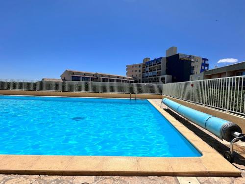 une piscine d'eau bleue dans une ville dans l'établissement saint ange Barcarès for 4, sea view pool WIFI, au Barcarès