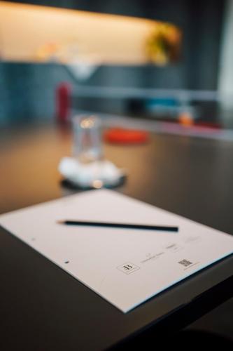 a pen and paper sitting on top of a table at Blue City Boutique Hotel in Baden