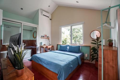 a bedroom with a blue bed and a mirror at Big Pet Friendly Family Villa, Coney Ville in Cituja