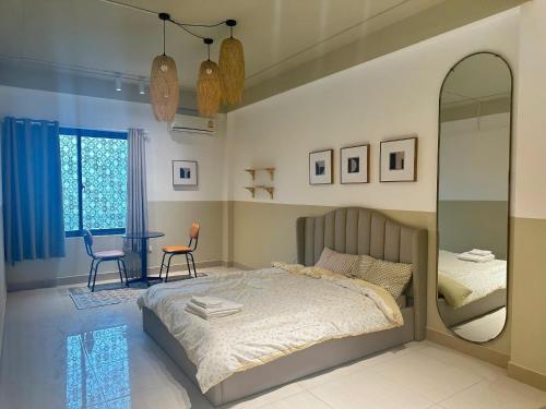 a bedroom with a bed and a mirror and a table at Luxe Paradise 21 Nguyen Van Troi in Hanoi