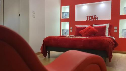 a red bedroom with a bed with a red headboard at Love Room Perpignan Jacuzzi & Ambiance romantique in Villeneuve-de-la-Raho