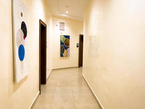 a hallway of an art gallery with paintings on the walls at City King Hotel in Kano