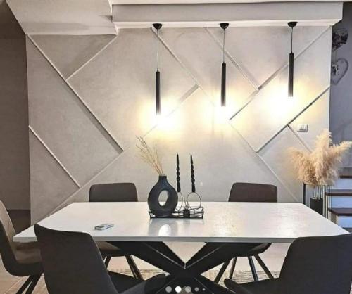 a dining room with a white table and chairs at Villa Rita in Orebić