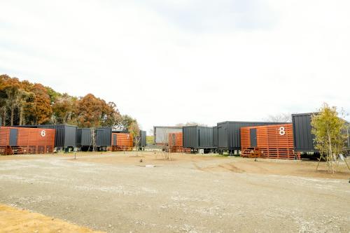 a group of train cars parked in a lot at No-12 Kasima Fan Zone in Kashima