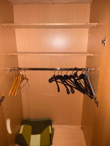a closet with shelves and hangers in a room at Beautiful apartment Osloß in Osloß