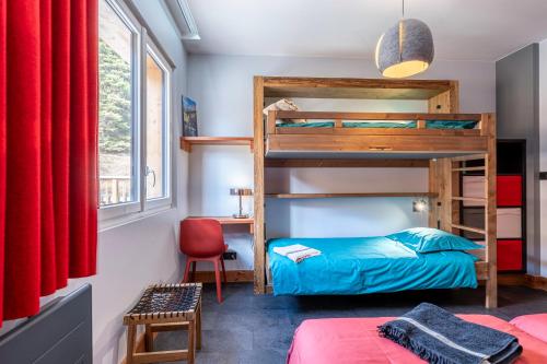 a bedroom with bunk beds and a red curtain at Près du Mélèze-Val Cenis-Sardières in Val Cenis