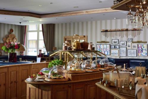 a restaurant with plates of food on a counter at Alt Lohbrügger Hof in Hamburg