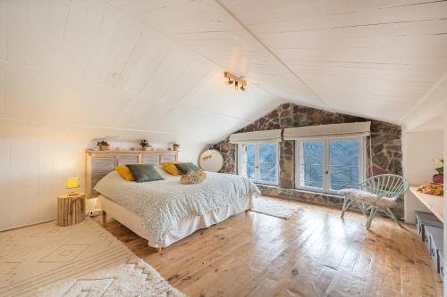 a bedroom with a large bed in a attic at La Bergerie des Cimes in Lantosque