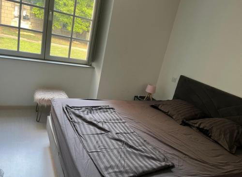 a large bed in a room with a window at Centre ville T3 in Saumur