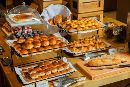 a buffet with various types of bread and pastries at HOTEL PIN Jiaoxi in Jiaoxi