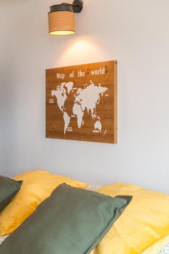 a map of the world hanging on a bedroom wall at La Bergerie des Cimes in Lantosque
