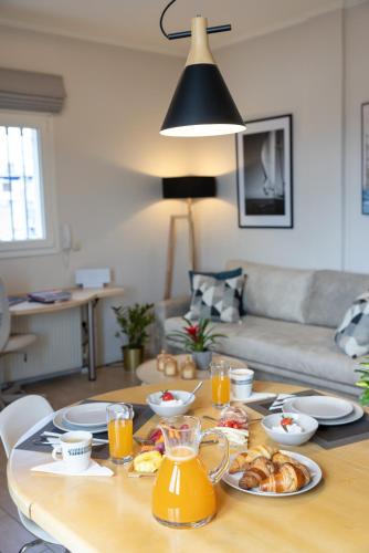 a table with food and orange juice on it at Unique apartment in Corfu Town