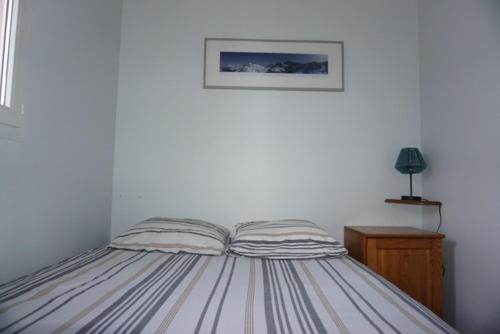 a bed in a bedroom with a picture on the wall at Clos saint michel in Luz-Saint-Sauveur