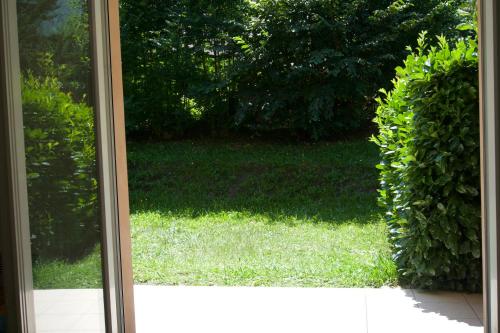 a view of a yard through a glass door at Clos saint michel in Luz-Saint-Sauveur