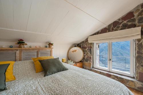 a bedroom with a large bed and a window at La Bergerie des Cimes in Lantosque