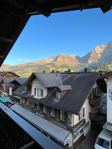 a view of the mountains from the balcony of a building at Hotel Bären in Adelboden