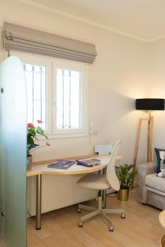 an office with a desk with a chair and a window at Unique apartment in Corfu Town