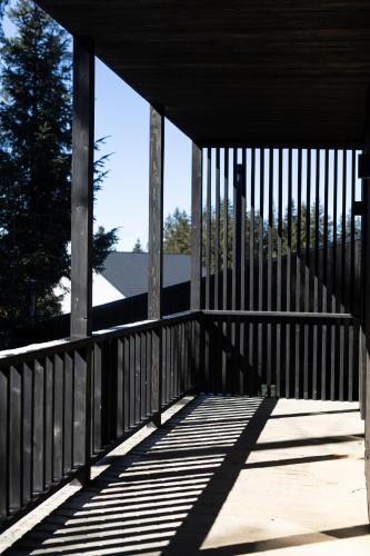 a wooden porch with the sun shining on it at Moho Будинки для відпочинку in Bukovel