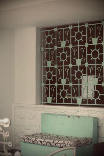 a room with a bench and a wall with a pattern at VILLA CALATHEA Varkala in Varkala