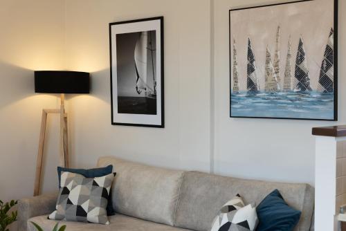 a living room with a couch and pictures on the wall at Unique apartment in Corfu Town