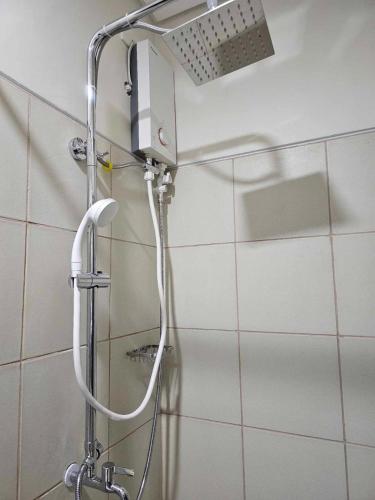 a shower with a shower head in a bathroom at SMDC Field REsidences condo unit in Manila