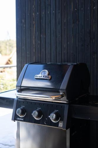 a grill with two knives on top of it at Moho Будинки для відпочинку in Bukovel