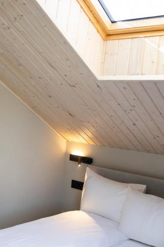 a bed in a room with a skylight at Moho Будинки для відпочинку in Bukovel