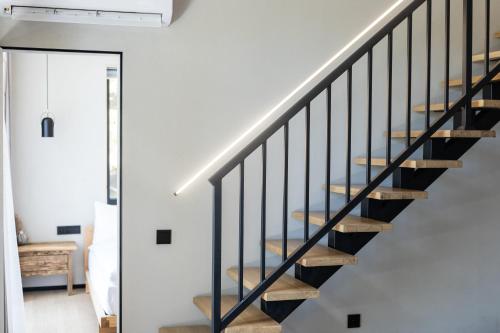 a staircase in a house with black railings at Moho Будинки для відпочинку in Bukovel