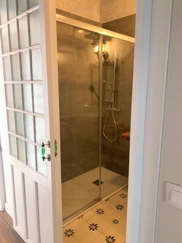 a shower in a bathroom with a glass door at Patios del Agua in El Puerto de Santa María
