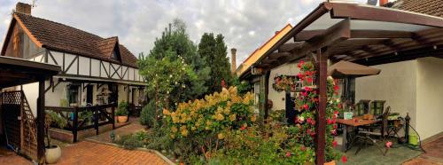 a house with a bunch of flowers in the yard at Appartement In Meiersberg Mit Grill in Grambin