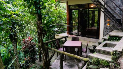 a house with a table and chairs in a garden at Forest Camp in Valencia