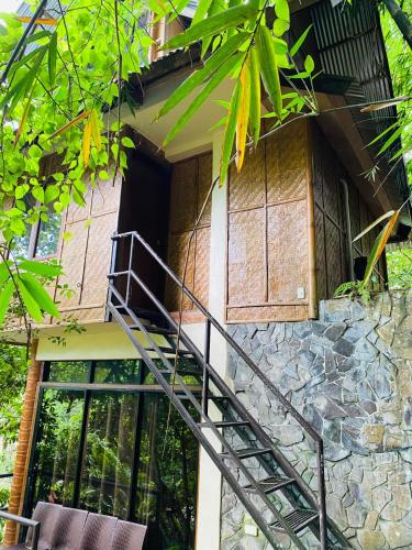 a staircase leading up to a house with a stone wall at Forest Camp in Valencia