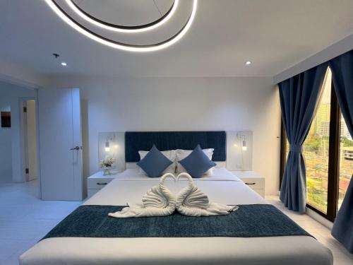 a bedroom with a large bed with two mens shoes at 88th Avenue in Cebu City
