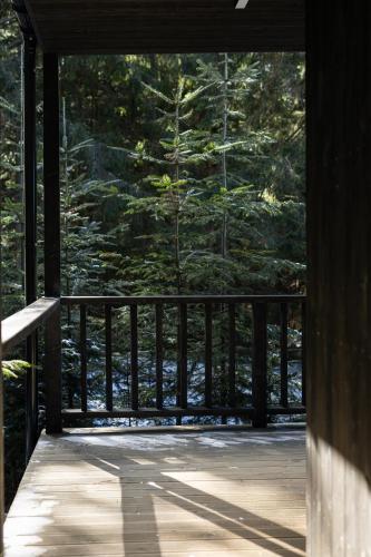 a screened in porch with a view of a pine tree at Moho Будинки для відпочинку in Bukovel