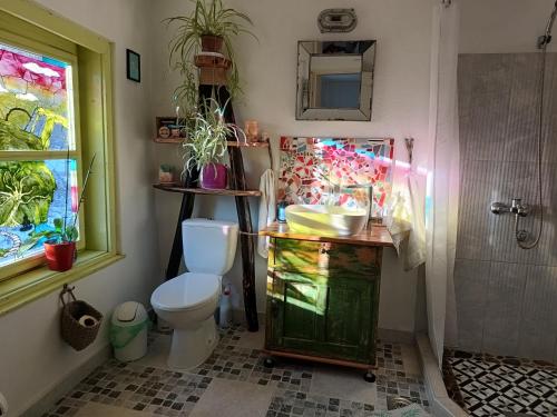 a bathroom with a toilet and a sink and a shower at Vila Dika in Poganovo