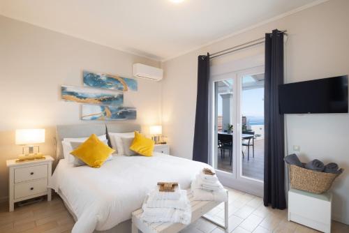 a bedroom with a bed and a view of the ocean at Unique apartment in Corfu Town