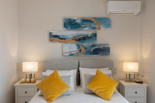a bedroom with a bed with two yellow pillows at Unique apartment in Corfu Town