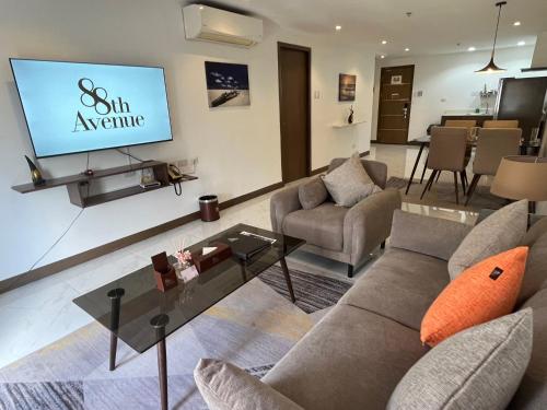 a living room with a couch and a tv at 88th Avenue in Cebu City