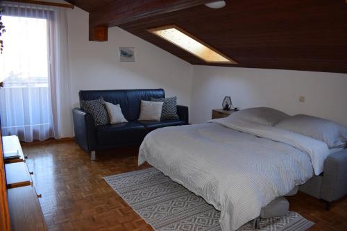 a bedroom with a bed and a chair and a skylight at Ferienhaus Gioia in Schruns-Tschagguns