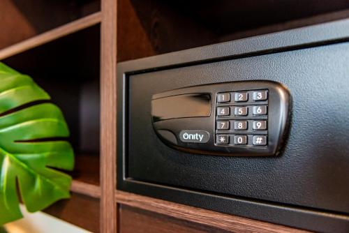 a black tv with a control panel in a cabinet at Bloomhotel in Lochristi