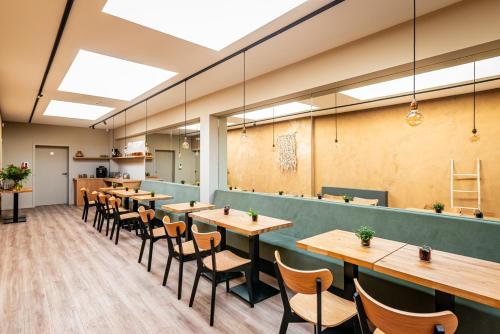 a row of tables and chairs in a restaurant at Bloomhotel in Lochristi