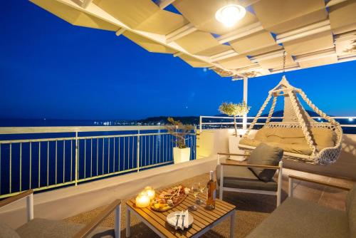 a room with a swing on a balcony at night at Unique apartment in Corfu Town