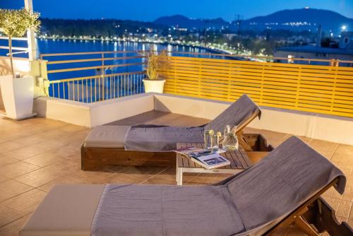 a balcony with a couch and a table on a ship at Unique apartment in Corfu Town
