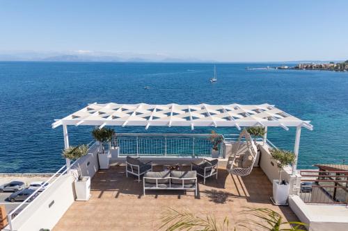 a patio with a white canopy over the water at Unique apartment in Corfu Town