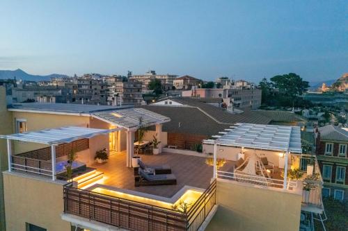 a house with a rooftop deck with lights on it at Unique apartment in Corfu Town