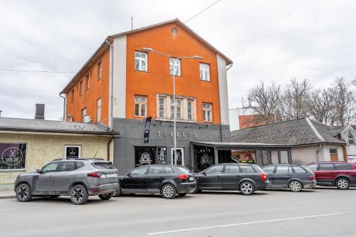 a group of cars parked in front of a building at Hotel Tērbata in Valmiera