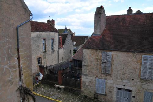 a group of old buildings in a city at Les Glycines Vézelay in Vézelay